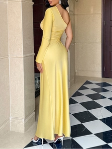 Full-length detail of elegant yellow one-shoulder evening gown with thigh-high slit