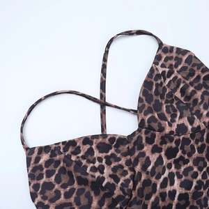 Detailed view of spaghetti straps and leopard print neckline with fine stitching