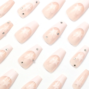 Pink French ombre press-on nails with white stars and rhinestones in long coffin shape