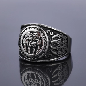 Vintage Viking bear claw ring in stainless steel with gothic embossed details on gray surface