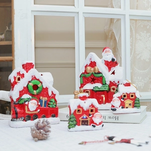 Lighted red and white ceramic Christmas house ornaments with warm festive holiday glow