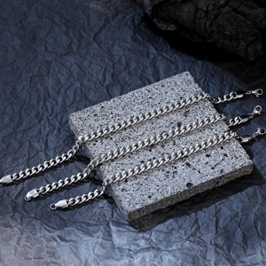 Detailed view of silver stainless steel curb chain with butterfly pendant on stone