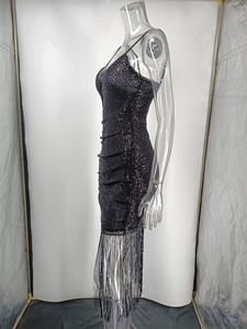 Side view detail of a black sequin fringe dress with v-neck straps on a mannequin