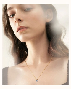 Close-up of elegant six-prong moissanite pendant on a gold chain necklace for women