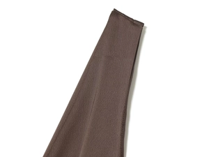 Detailed view of the fine horizontal texture on dark brown satin dress fabric