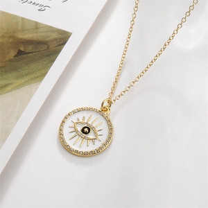 Detail of gold evil eye necklace with white enamel and sparkling rhinestones