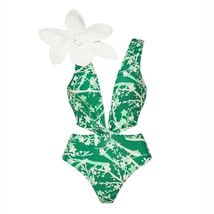 Close-up of green deep V swimsuit with white floral print and a 3D fabric flower detail