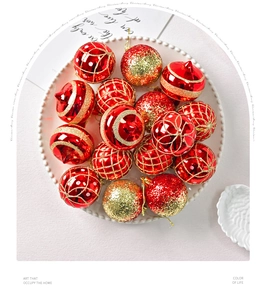 Detail of red and gold Christmas ornaments set with mixed textures in a white tray