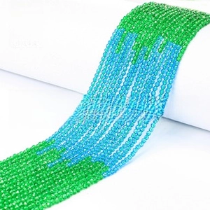 Close-up of 3mm faceted natural stone beads in green and blue for jewelry making