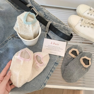 Detail of breathable low cut boat socks featuring embroidered bows and ribbed cuffs
