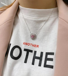 Detail of pink heart-shaped crystal pendant necklace worn on a silver S925 chain