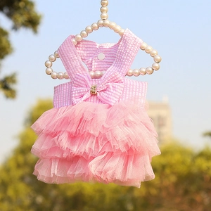 Detailed view of a pink striped pet dress with a mesh tutu and elegant bow decoration