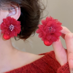 Detailed view of red tulle floral earrings with crystal fringe and polished beads