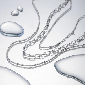 Minimalist triple-layer silver stainless steel necklace with water droplet reflection