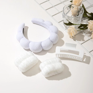 Close-up of white cloud sponge headband set with wristbands and large hair claw clip