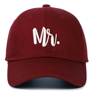 Detail of white 3D Mr embroidery on a burgundy cotton baseball cap with neat stitching