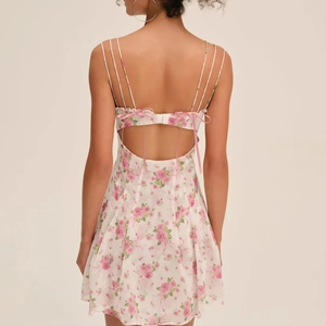 Floral A-line backless dress with cross straps and bow detail in pink and white