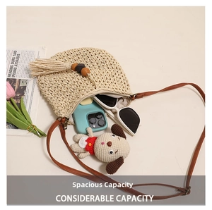 Detail view of woven straw crossbody bag showing internal capacity with wood bead tassels