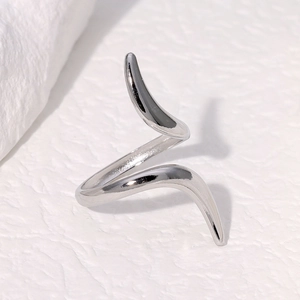 Minimalist silver titanium steel spiral open ring for women on a white textured background
