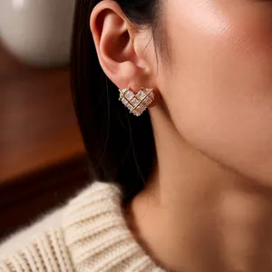 Exquisite 18k gold plated heart stud earrings with cubic zirconia on model