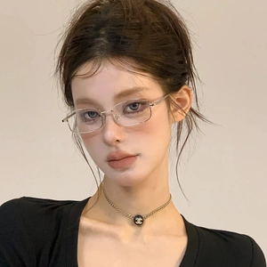 Vintage small silver metal frame clear lens glasses for women in a retro minimalist style