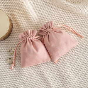Detail view of pink velvet drawstring pouches for jewelry storage and gift packaging