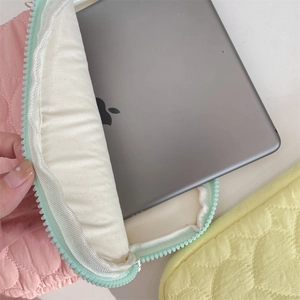 Detail of pink and yellow quilted iPad case showing zipper and soft plush lining