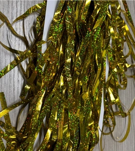Close-up of golden laser holographic tinsel curtain fringe for party backdrop decoration