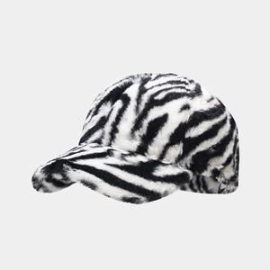 Close-up of zebra print faux fur baseball cap showing thick plush texture and warm material