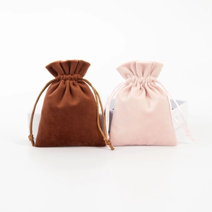 Detailed view of brown and pink velvet drawstring jewelry pouches with soft texture