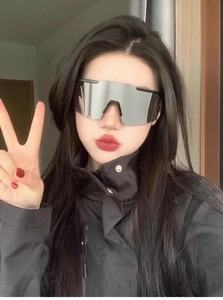 Close-up of oversized cycling sunglasses with silver mirror lenses and black temples