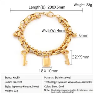 Detailed view of double-layer gold titanium steel bracelet with lock and key charms