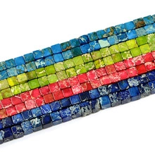 Macro shot of 8mm faceted square strawberry crystal stone beads in four vibrant colors