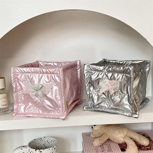 Detail view of quilted square PU organizer baskets with embossed butterflies and lace bows