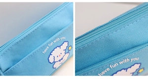 Detail of blue canvas pencil case showing durable fabric texture and cute puppy print