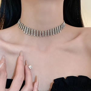 Macro view of wide silver-toned choker necklace with four-layered crystal fringe details