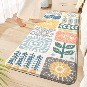 Cozy bedroom scene showing a floral PVC coil floor mat on wood flooring with bare feet