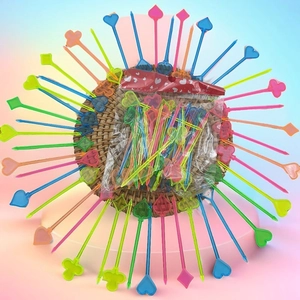 Macro view of colorful plastic fruit picks with card suit shapes in creative packaging