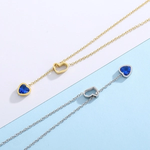 Y-shaped necklace with open heart link and deep blue heart gem charm in gold and silver