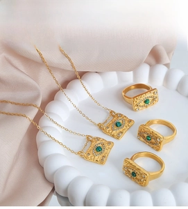 Retro 18k gold plated evil eye jewelry set with green stone on ceramic tray