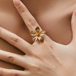Elegant 18K gold-plated floral ring with brushed metal texture and minimalist flower design