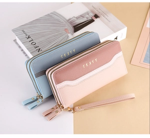 Detailed view of dual-zipper long leather wallets with lychee texture and wrist strap