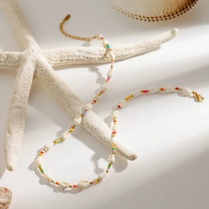 Detail of beaded necklace with conch pearls and sea shells for beach vacation style