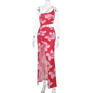Detail of red floral two-piece set with one-shoulder crop top and side slit maxi skirt