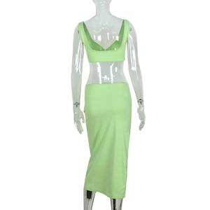Back view of neon green two-piece set featuring cropped halter top and bodycon midi skirt