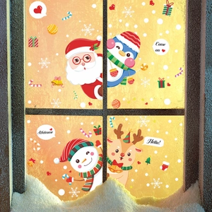 Christmas window stickers featuring Santa, penguin, and snowman on snowy glass background