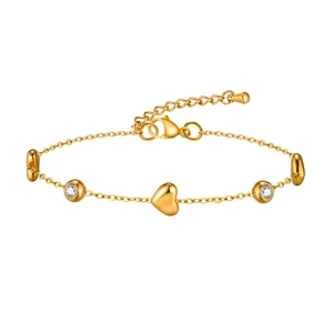 Bracelet chaîne croisée plate en acier doré avec breloques cœur et pierres zircon