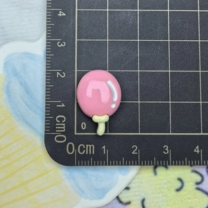 Detail showing pink ice cream resin charm size measurement of 1.5cm x 2cm with ruler