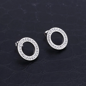 Close-up of silver stainless steel round stud earrings with shimmering pavé zircon stones