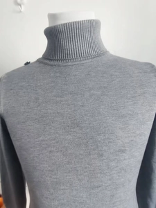 Detailed view of the ribbed knit texture and turtleneck design on this grey men sweater